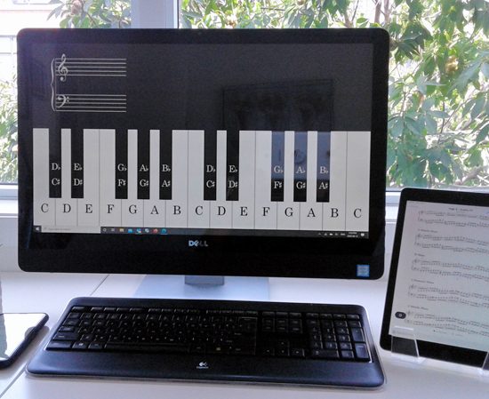 Student taking a music lesson online from a laptop at home